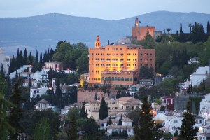 a large building with a mountain in the background