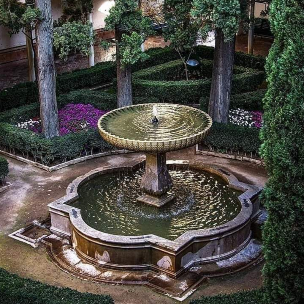 a garden with water in the background