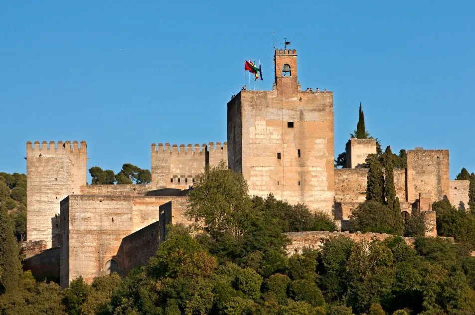 a castle with a clock tower in front of a brick building
