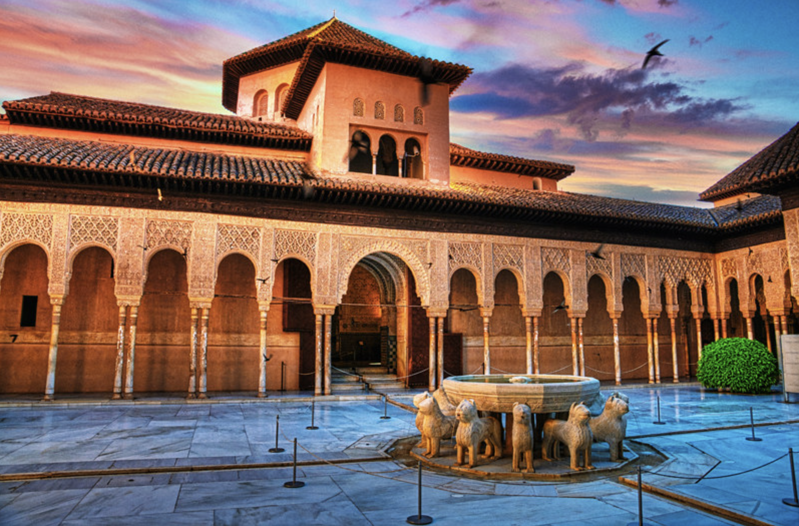 patio de los leones a group of people in front of a building